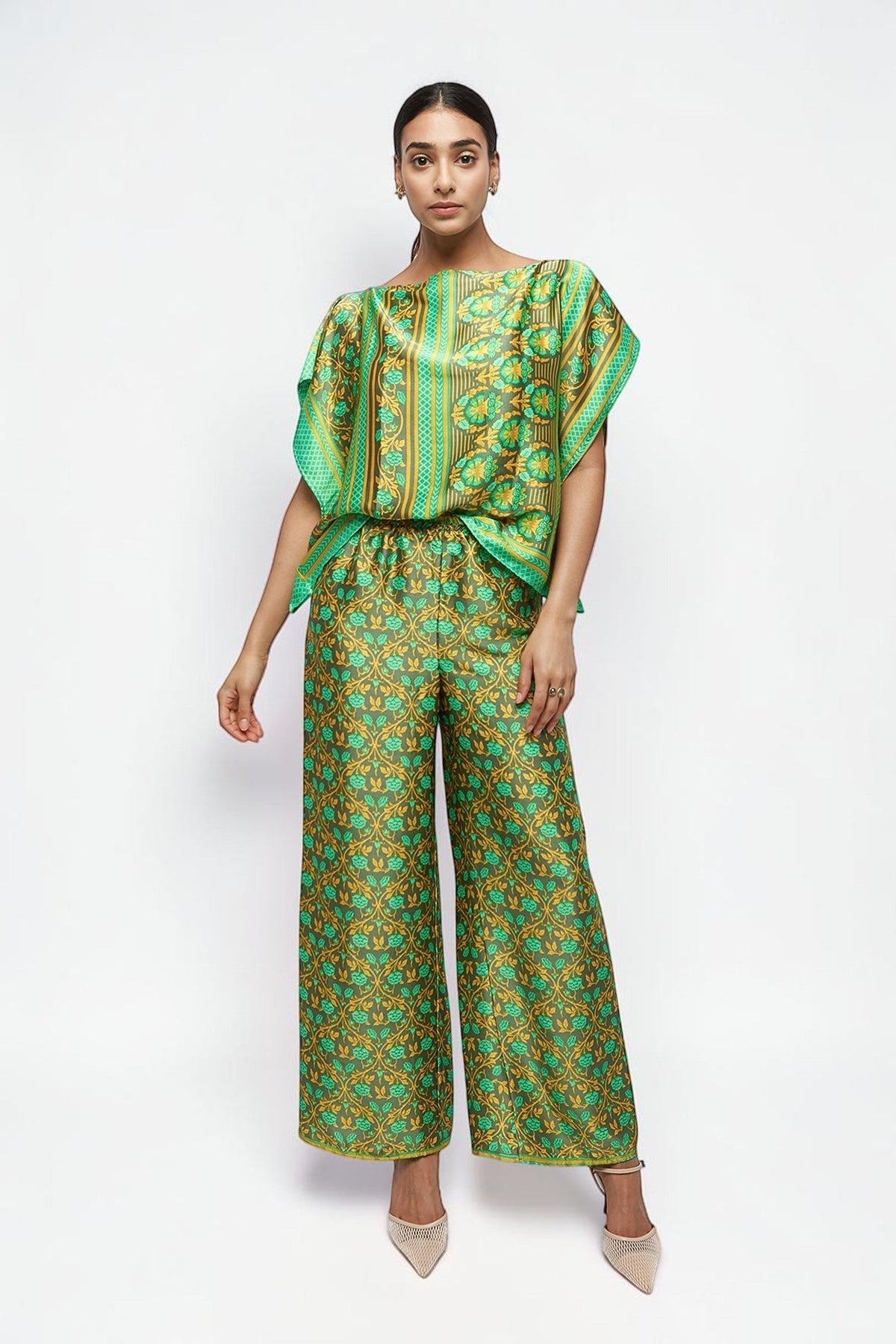 ALBANA New York silk wide leg pants in sage green with vibrant ethnic floral print and elastic waist on a model