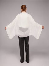 Model wearing ALBANA New York sheer white bolero sleeves with delicate embroidered trim on collar and cuffs