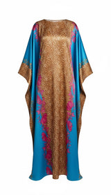 ALBANA New York silk kaftan in turquoise and gold with a mixed animal print, floral motifs, and wide sleeves.