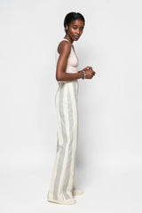 ALBANA New York mid-rise cotton flare pants with vertical stripes worn by a model in a side profile view.