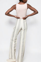 ALBANA New York mid-rise cotton flare pants with vertical stripes and double pleats, back view on a model.