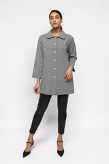 ALBANA New York textured button-down collared jacket in black and white geometric print worn with black trousers